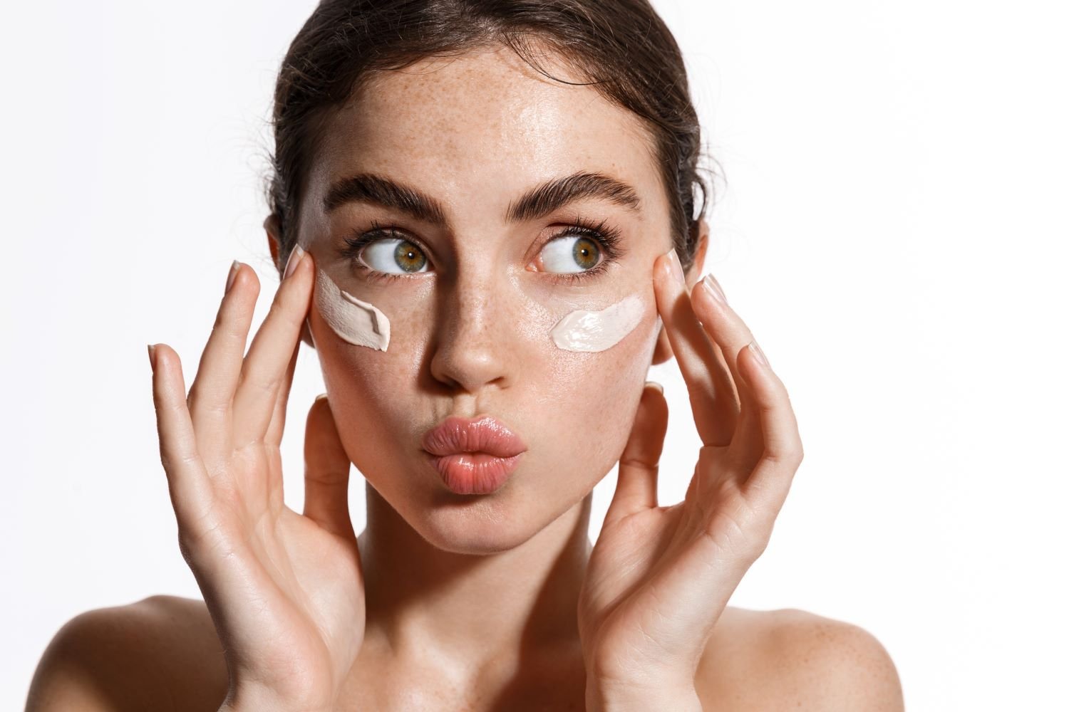 a girl with face cream on her face for skincare marketing
