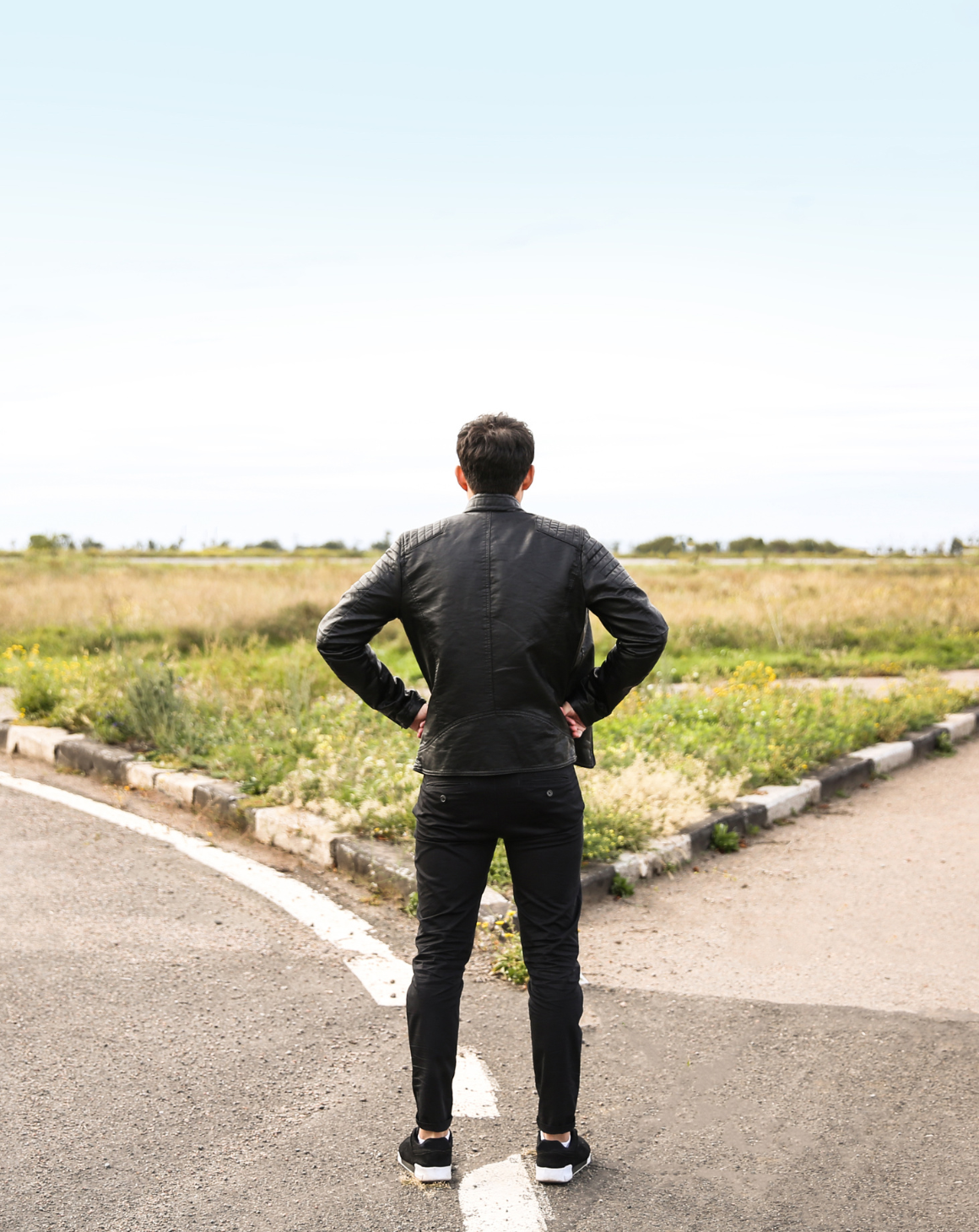 A man standing at a crossroad