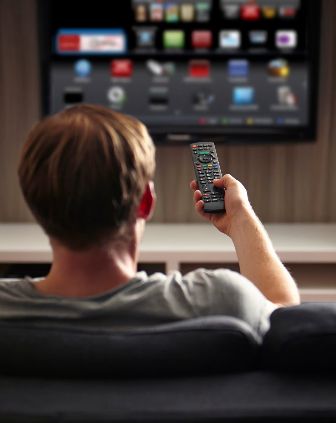 A man watching a smart TV