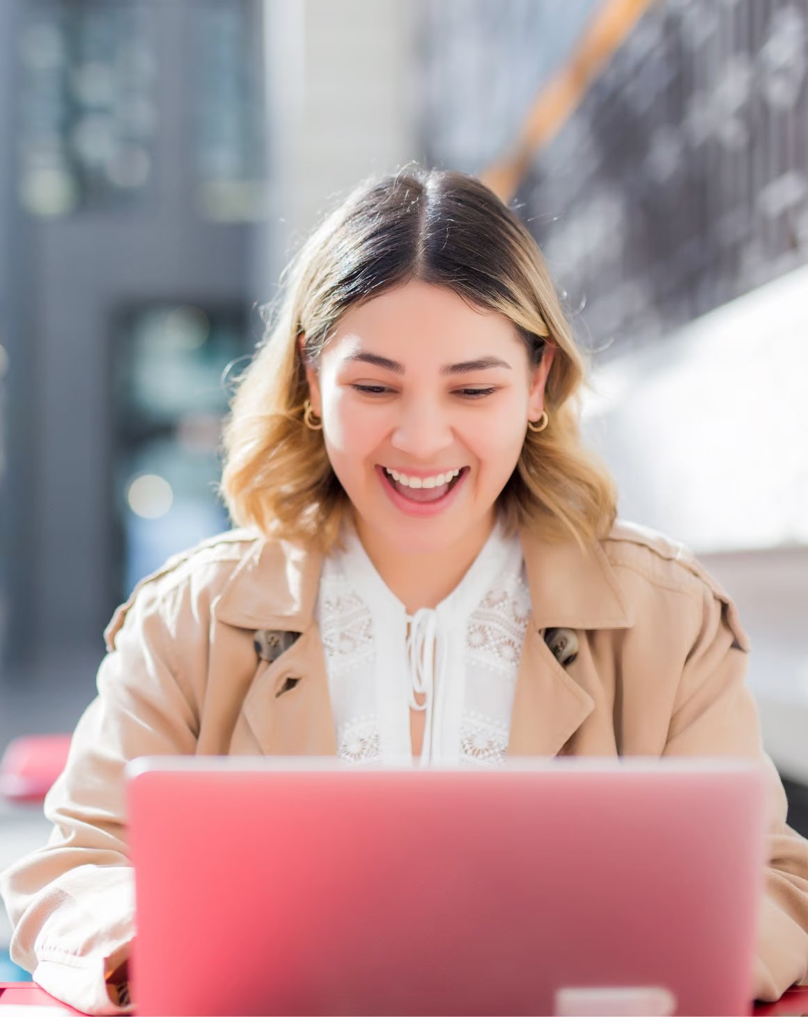 an image of a girl using a laptop computer outside and smiling