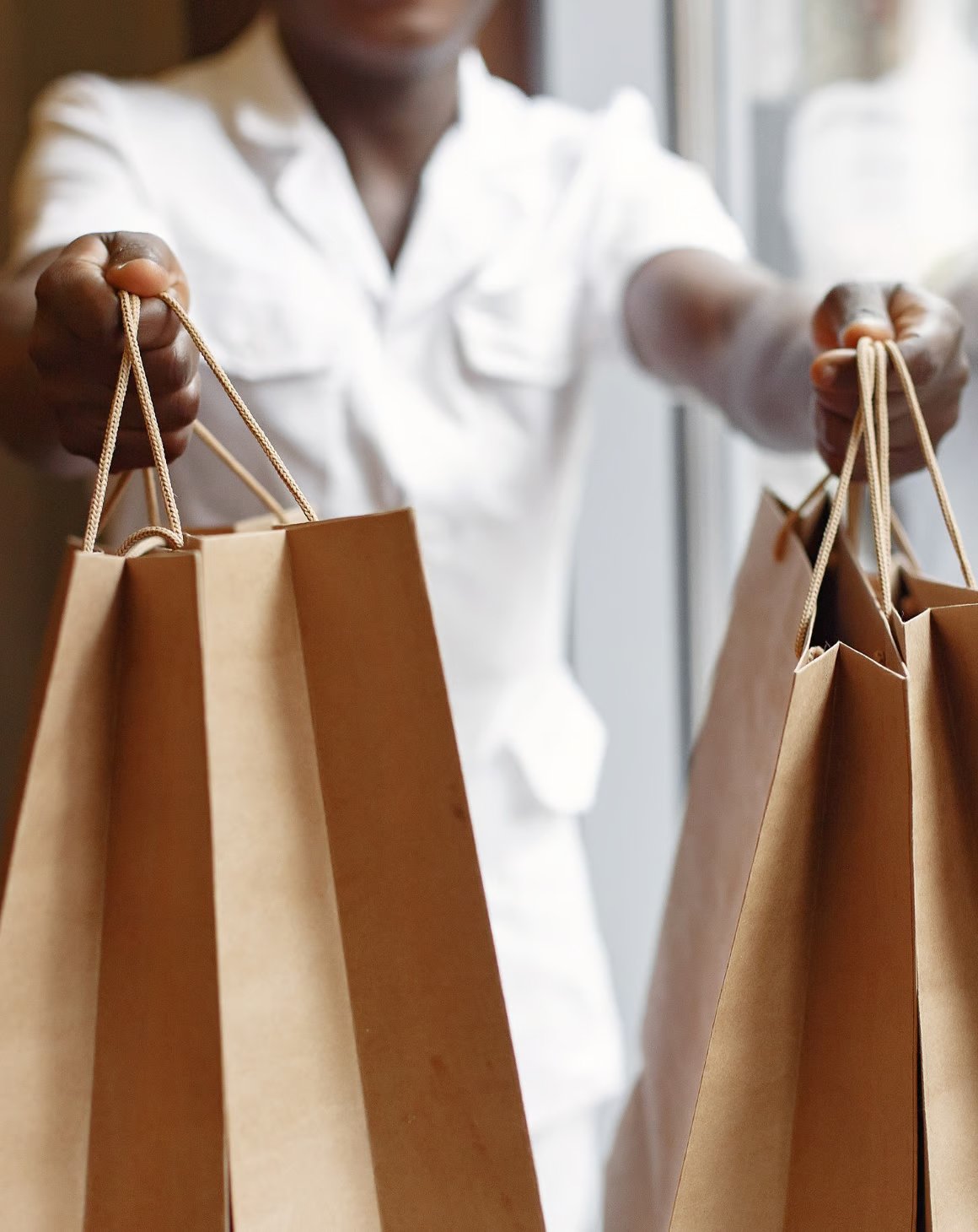 A woman holding shopping bags with an online order in a store 