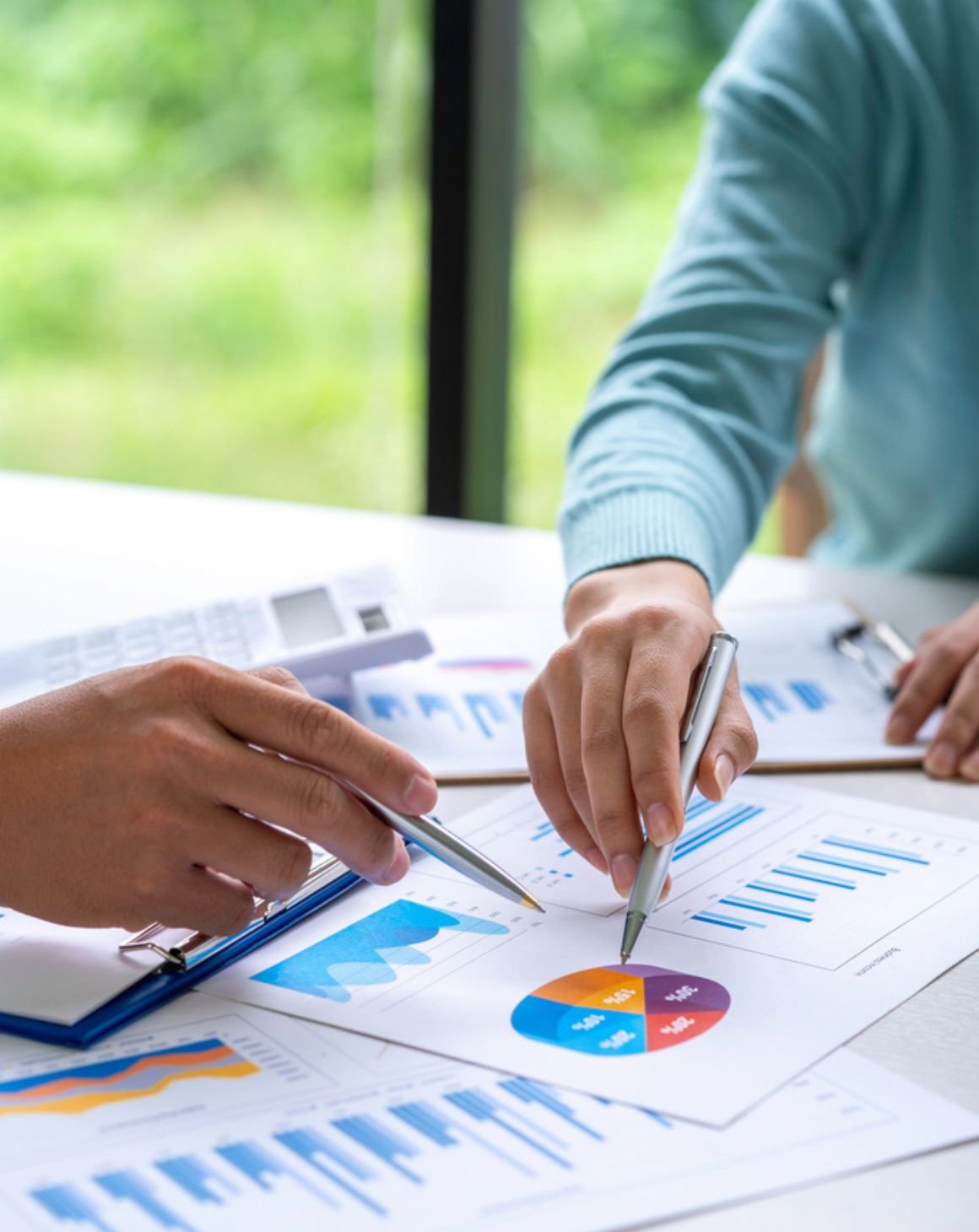 two people pointing at a report