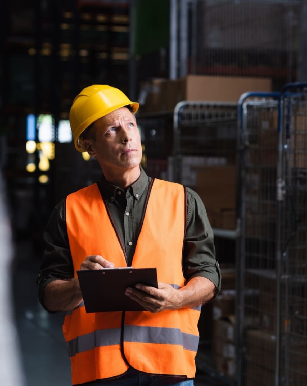 warehouse worker with a clipboard looking at stock