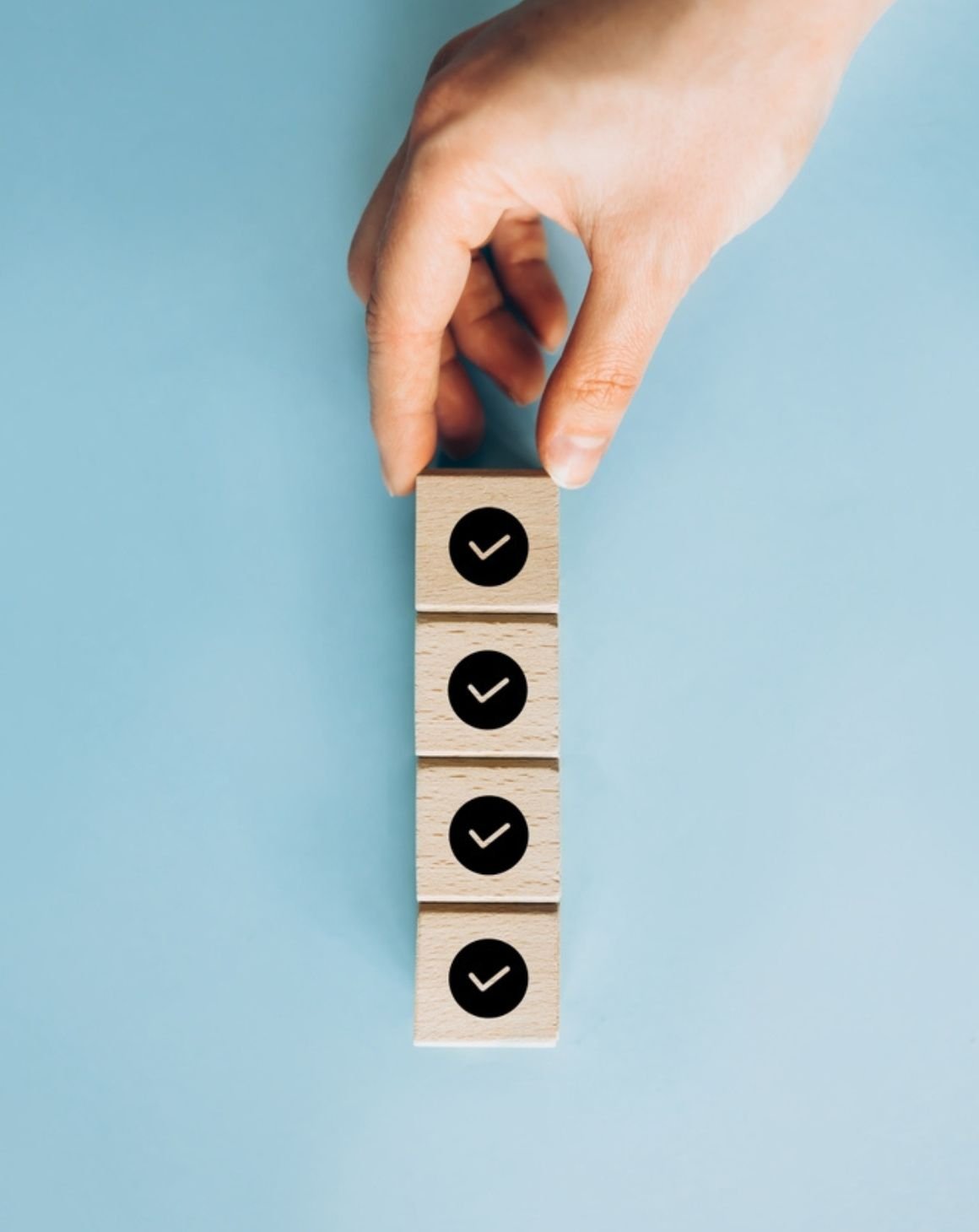 a person holds a wooden blocks with check mars