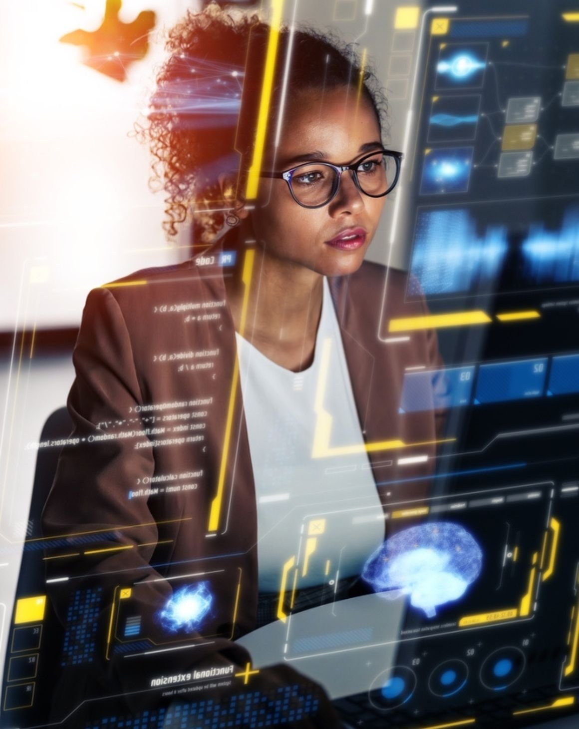 woman wearing glasses stares at a computer displaying a dashboard