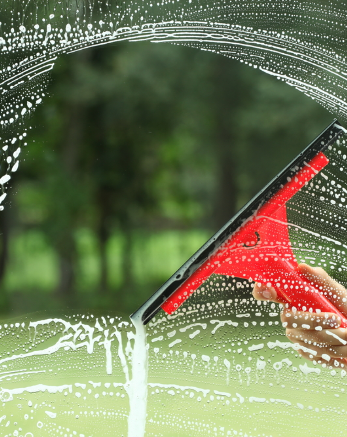 window getting cleaned with squeegee