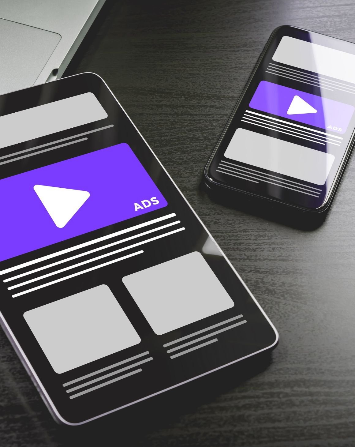 two mobile phones with video ads on a desktop