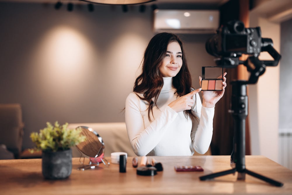 A beauty influencer recording a video for a product review