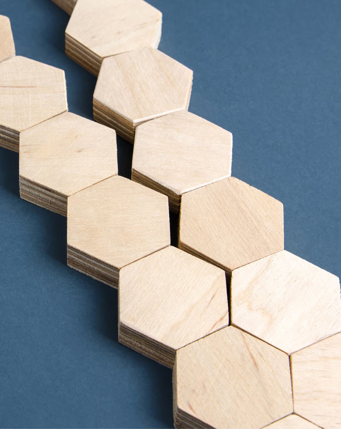 A close-up view of hexagon-shaped wooden tiles arranged in a geometric pattern.