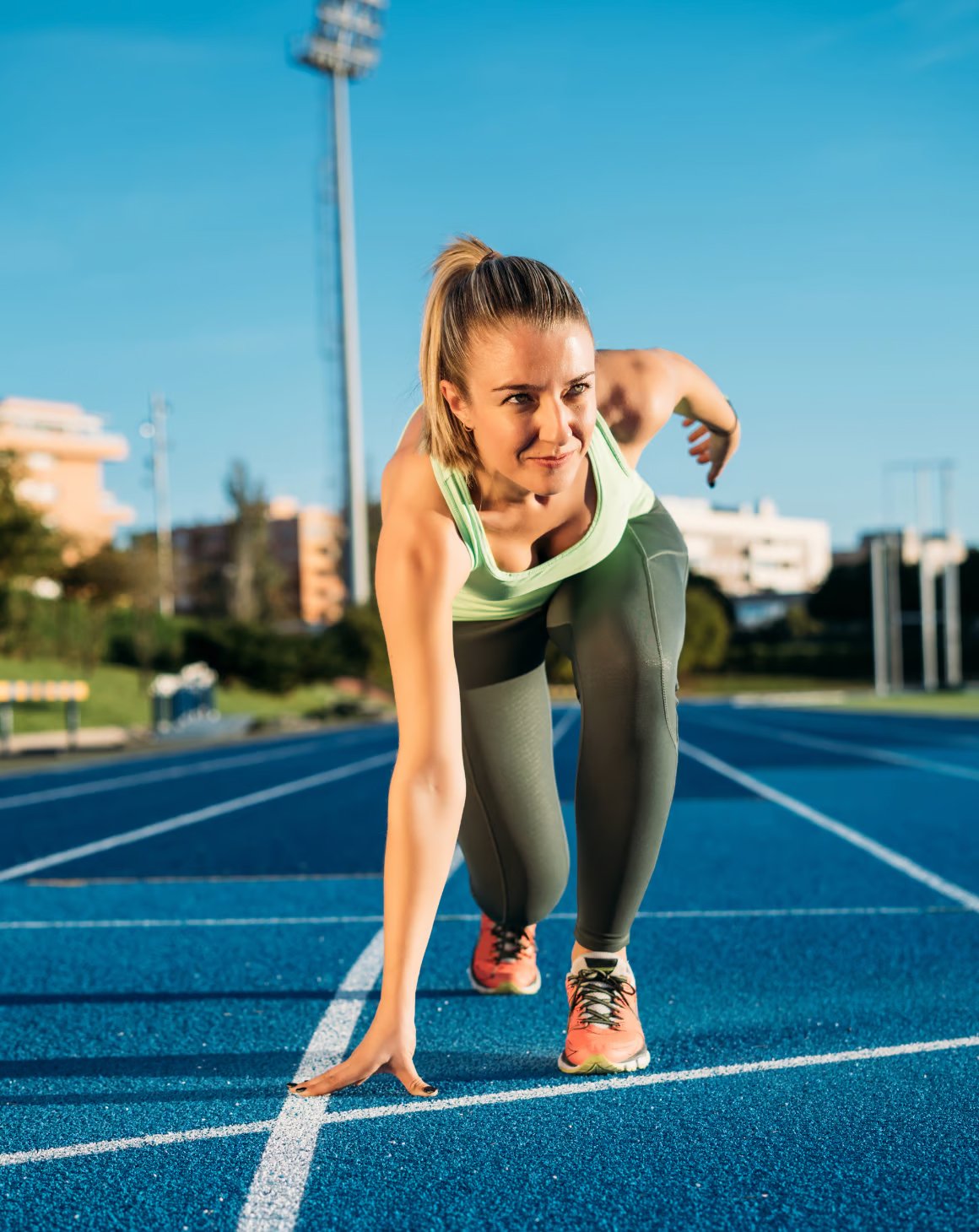 a woman on a race track ready to start running