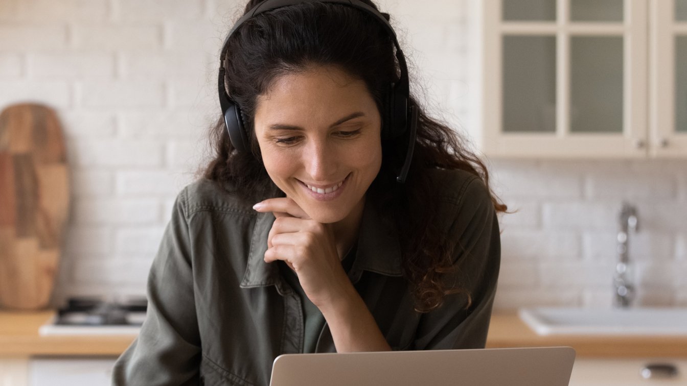 A woman watching a conference online