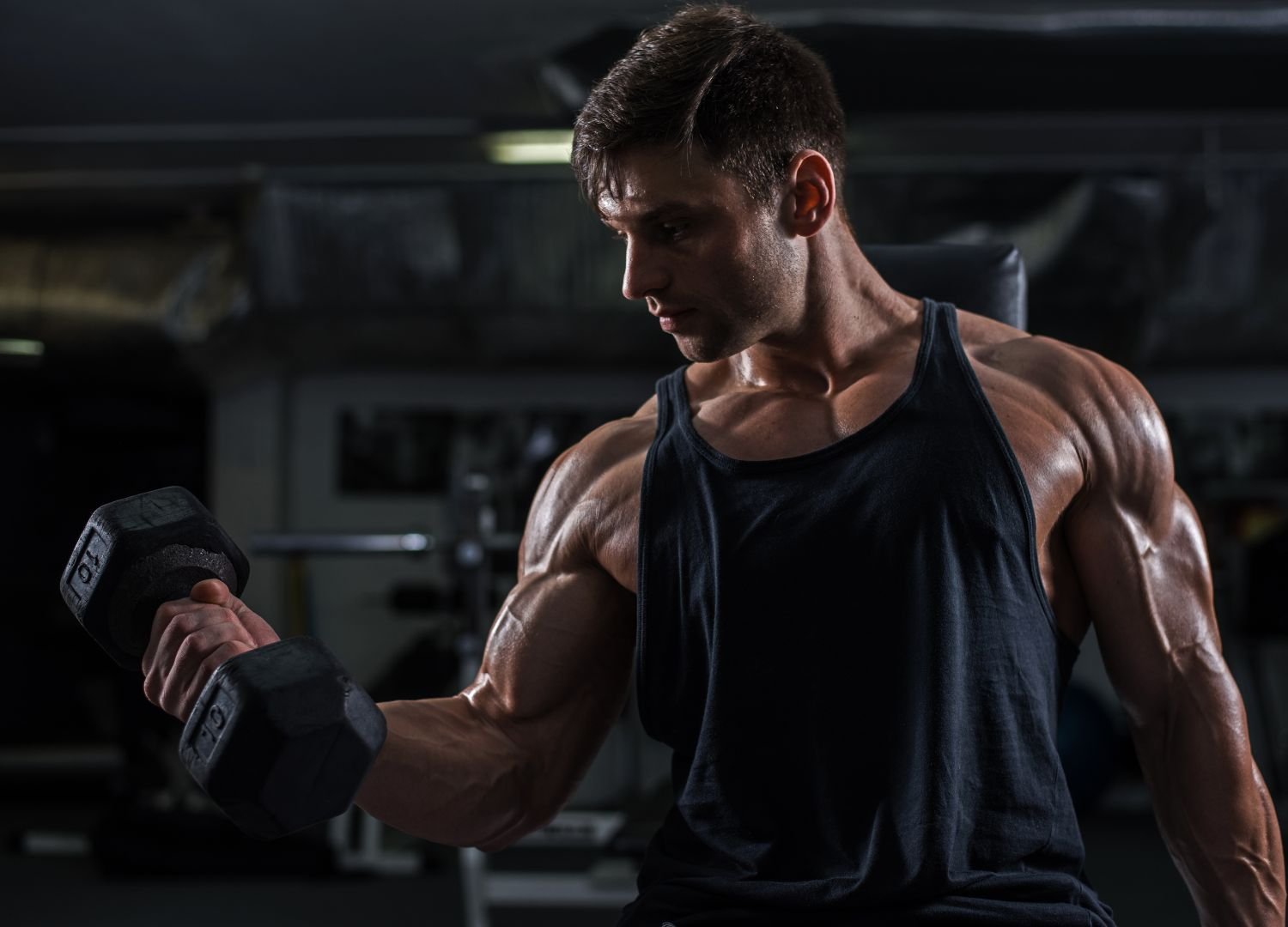 A PowerBlock man lifting weights in a gym