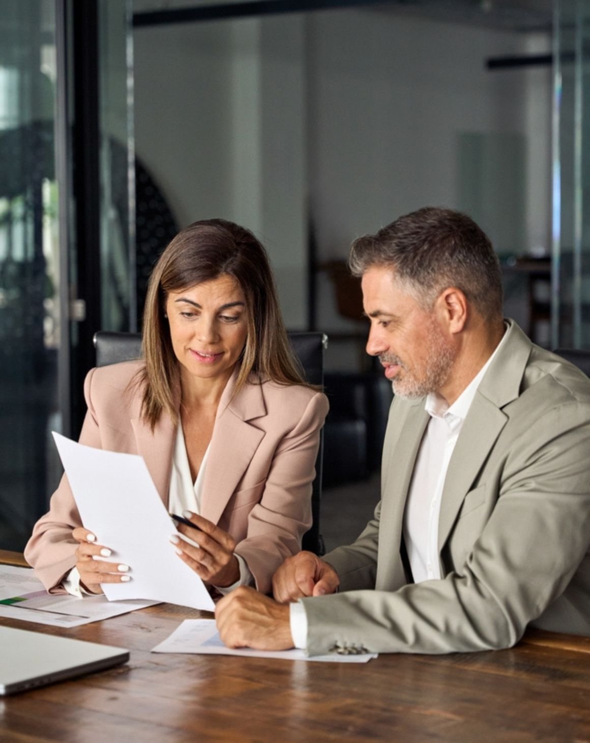 a man and a woman looking at a report