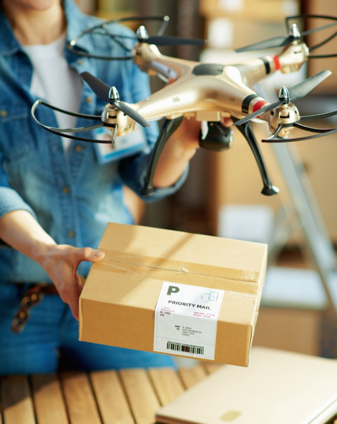 a woman displays a box with a drone